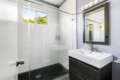 Bathroom with a sink, mirror, and shower at Ocotillo, Palm Springs