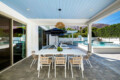 Outdoor dining area with a table and chairs by the pool at Ocotillo, Palm Springs