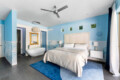 Bedroom with a bed, freestanding bathtub, and gold-framed mirror at Ocotillo, Palm Springs