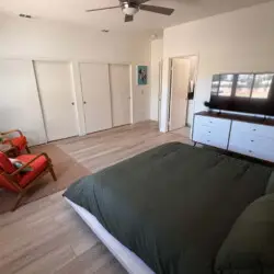 Bedroom with bed and dresser at Sunset Sands in Palm Springs