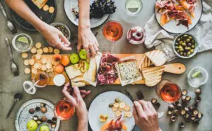 Summer picnic with wine and snacks, including a charcuterie board and rose wine