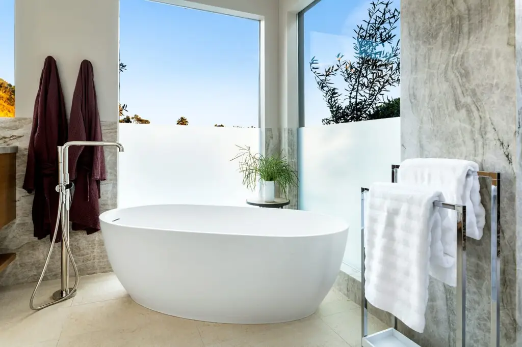 Bathroom with freestanding bathtub and towel rack