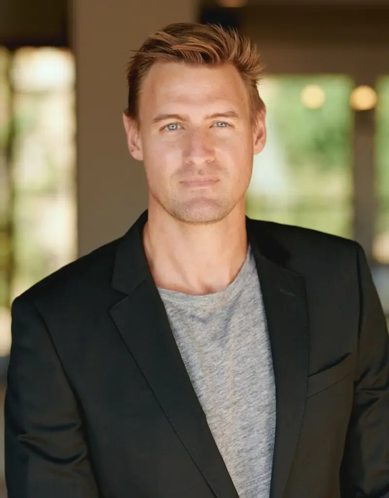 Portrait of a man wearing a blazer and a t-shirt - by Open Air Homes.