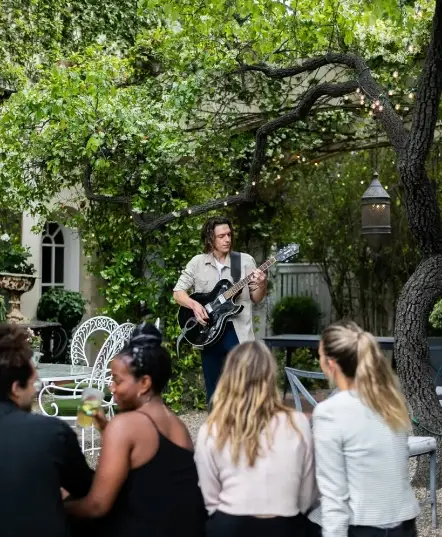 Outdoor gathering with guitar player