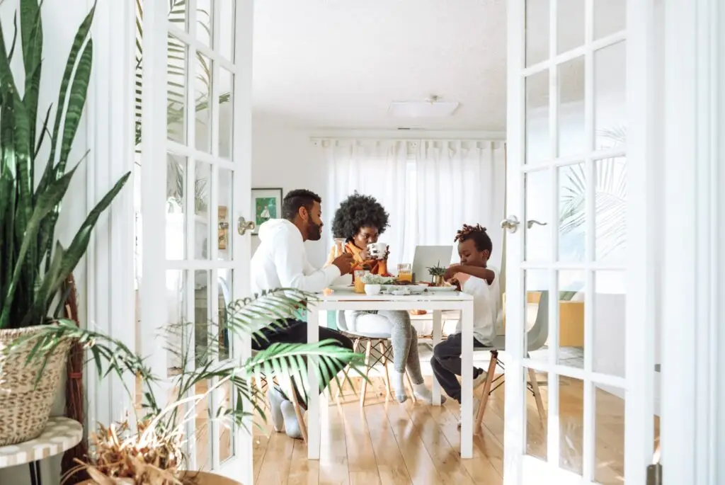 Family sitting at a dining table, enjoying a meal together.