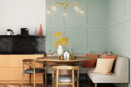 Dining area with a table, chairs, a bench, and a chandelier.