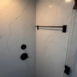 Shower area with towel rack and marble tiles at Malibu Breeze.