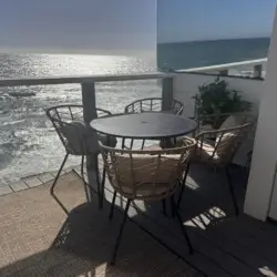 Patio area with table and chairs overlooking the ocean at Malibu Breeze.