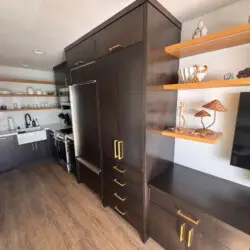 Kitchen area with cabinets, sink, and refrigerator at Malibu Breeze.