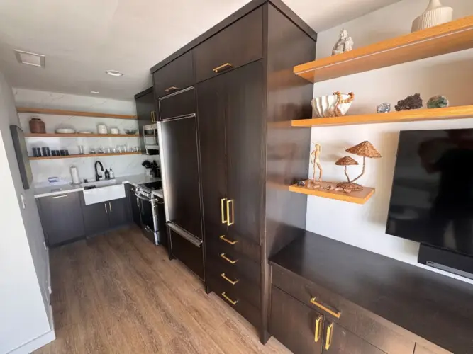 Kitchen area with cabinets, sink, and refrigerator at Malibu Breeze.