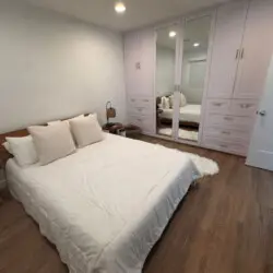 Bedroom with bed, pillows, and wardrobe at Malibu Breeze.