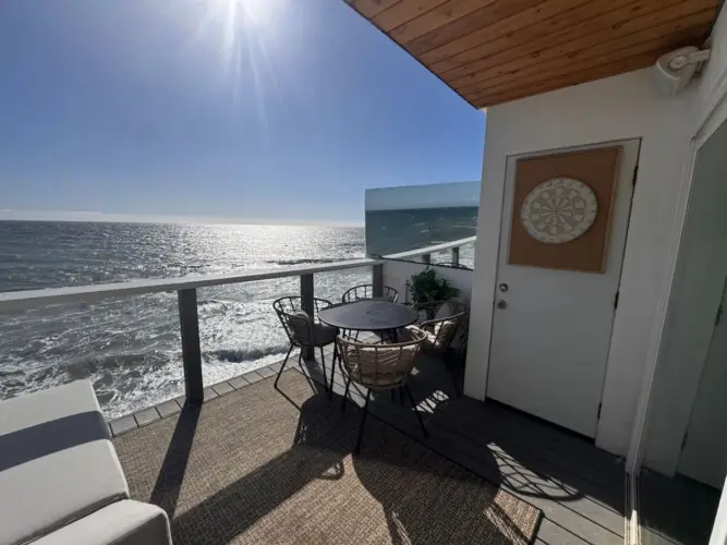 Patio area with table and chairs overlooking the ocean at Malibu Breeze.