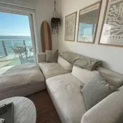 Living room with sofa, coffee table, and wall art at Malibu Breeze.