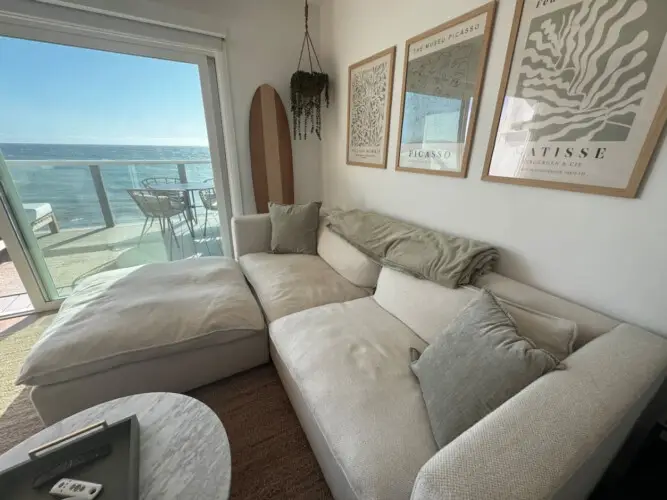 Living room with sofa, coffee table, and wall art at Malibu Breeze.