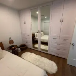 Bedroom with bed, mirrored wardrobe, and side table at Malibu Breeze.