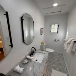 Bathroom with marble countertop at Beverly Grove Tudor Family Home - by Open Air Homes.