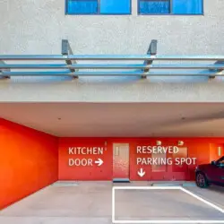 Parking area with reserved parking spot and kitchen door at La Mirage by Open Air Homes: Contemporary + Pool – by Open Air Homes.