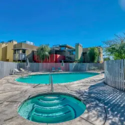 Swimming pool and hot tub at La Mirage gated community in Palm Springs, offering a luxurious outdoor experience – by Open Air Homes.