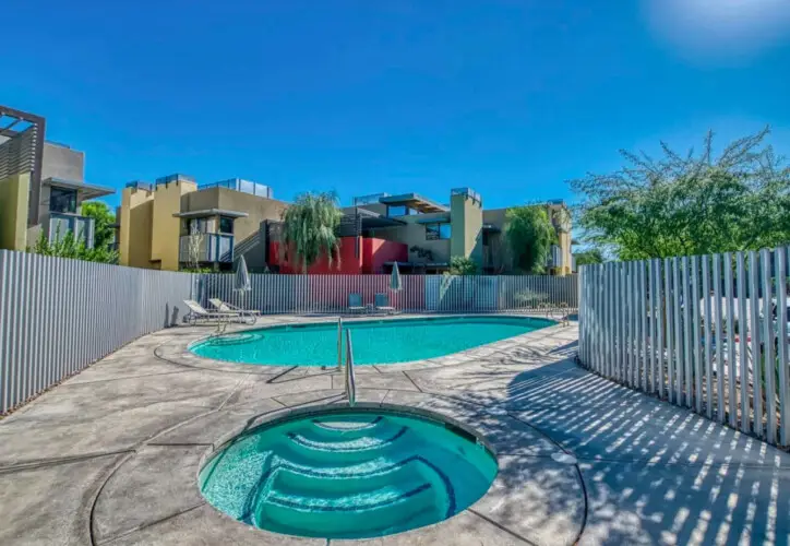 Swimming pool and hot tub at La Mirage gated community in Palm Springs, offering a luxurious outdoor experience – by Open Air Homes.