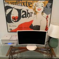 Workspace setup with computer monitor, printer, and lamp in front of a Marilyn Monroe poster at La Mirage gated community in Palm Springs – by Open Air Homes.