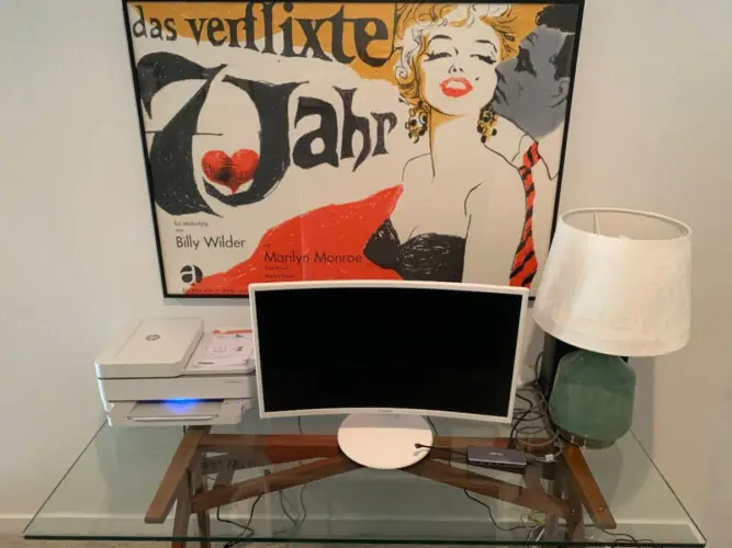 Workspace setup with computer monitor, printer, and lamp in front of a Marilyn Monroe poster at La Mirage gated community in Palm Springs – by Open Air Homes.