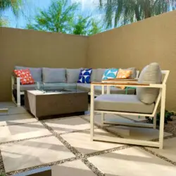 Outdoor seating area with fire pit at La Mirage gated community in Palm Springs, offering a cozy and modern setting – by Open Air Homes.