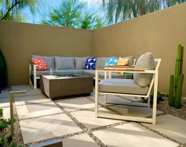 Outdoor seating area with fire pit at La Mirage gated community in Palm Springs, offering a cozy and modern setting – by Open Air Homes.