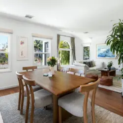 Dining area with wooden table and chairs at Sun-Drenched Spanish Manor in Mar Vista - by Open Air Homes.