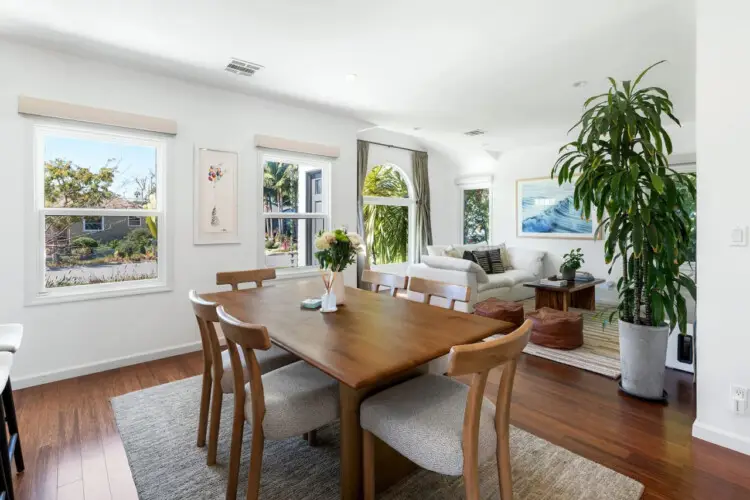 Dining area with wooden table and chairs at Sun-Drenched Spanish Manor in Mar Vista - by Open Air Homes.