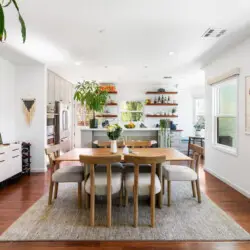 Dining room with wooden table and chairs at Sun-Drenched Spanish Manor in Mar Vista - by Open Air Homes.