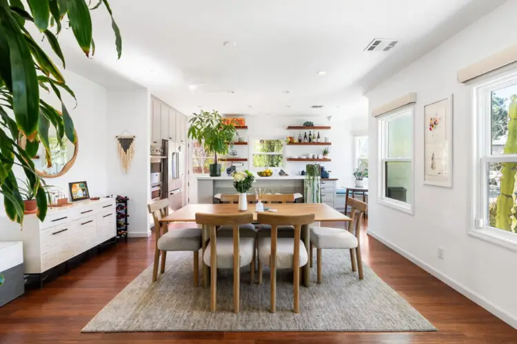 Dining room with wooden table and chairs at Sun-Drenched Spanish Manor in Mar Vista - by Open Air Homes.