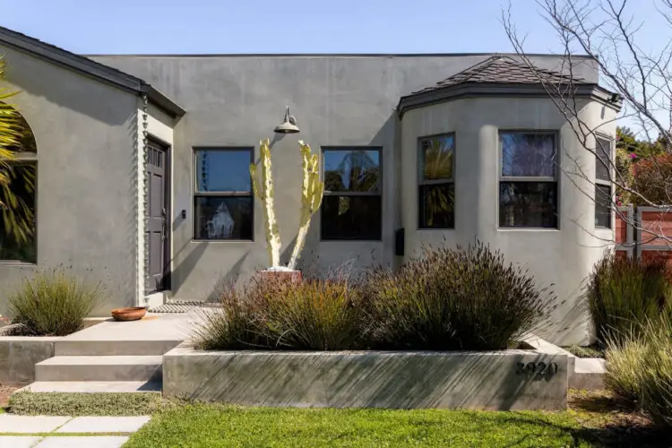 Exterior of house with gray facade and cactus