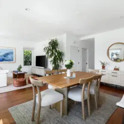 Dining area with wooden table and chairs at Sun-Drenched Spanish Manor in Mar Vista - by Open Air Homes.