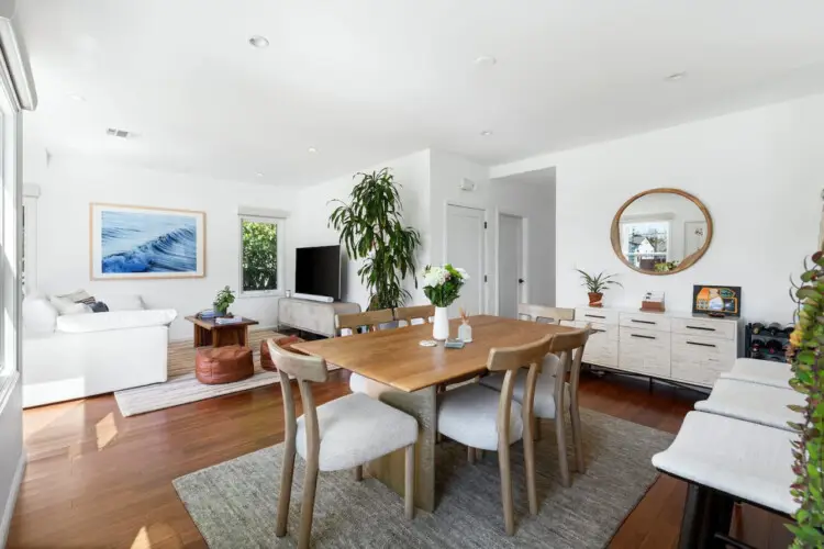 Dining area with wooden table and chairs at Sun-Drenched Spanish Manor in Mar Vista - by Open Air Homes.