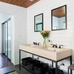 Bathroom with large vanity, two sinks, and wooden ceiling at Sun-Drenched Spanish Manor in Mar Vista - by Open Air Homes.