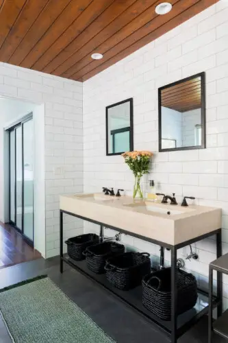 Bathroom with large vanity, two sinks, and wooden ceiling at Sun-Drenched Spanish Manor in Mar Vista - by Open Air Homes.