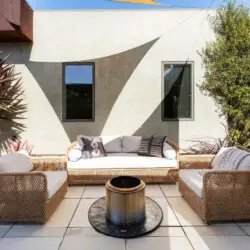 Outdoor seating area with fire pit at Sun-Drenched Spanish Manor in Mar Vista - by Open Air Homes.