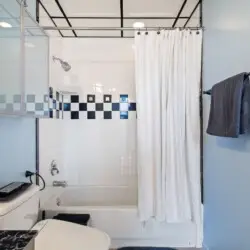 Bathroom with shower and toilet at Skyline View Loft with Chef's Kitchen: DTLA - by Open Air Homes.