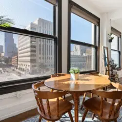 Comfortable bedroom with a bed, side tables, TV, and decorative elements at Skyline View Loft with Chef's Kitchen: DTLA - by Open Air Homes.