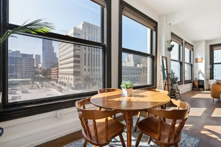 Comfortable bedroom with a bed, side tables, TV, and decorative elements at Skyline View Loft with Chef's Kitchen: DTLA - by Open Air Homes.