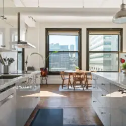 Modern kitchen with city views at Skyline View Loft with Chef's Kitchen: DTLA - by Open Air Homes.