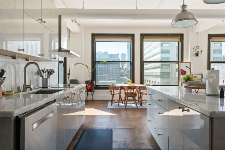 Modern kitchen with city views at Skyline View Loft with Chef's Kitchen: DTLA - by Open Air Homes.