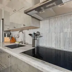 Modern kitchen sink and counter at Skyline View Loft with Chef's Kitchen: DTLA - by Open Air Homes.