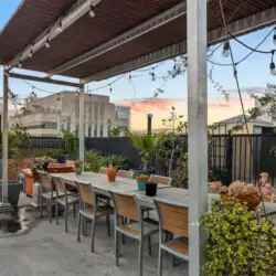 Rooftop patio with dining area and city skyline views