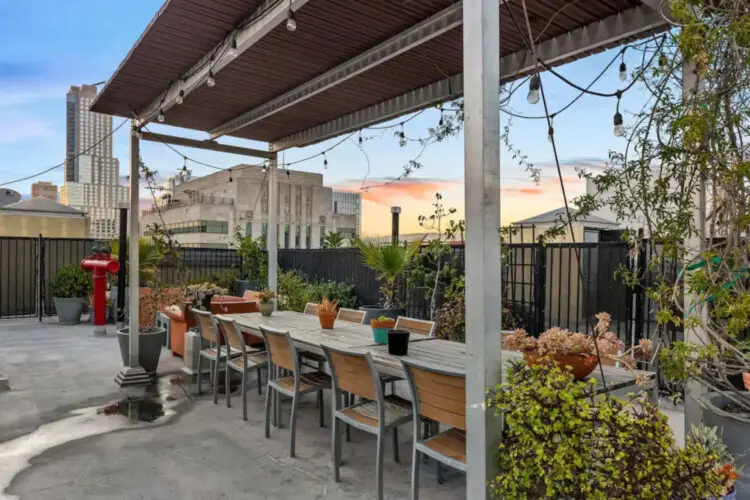 Rooftop patio with dining area and city skyline views