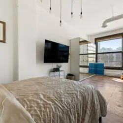 Bedroom with city views at Skyline View Loft with Chef's Kitchen: DTLA - by Open Air Homes.