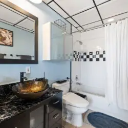 Bathroom with shower and toilet at Skyline View Loft with Chef's Kitchen: DTLA - by Open Air Homes.