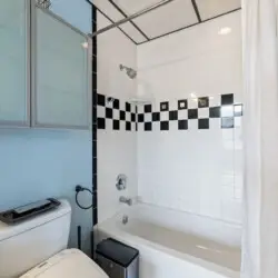 Bathroom with shower and toilet at Skyline View Loft with Chef's Kitchen: DTLA - by Open Air Homes.