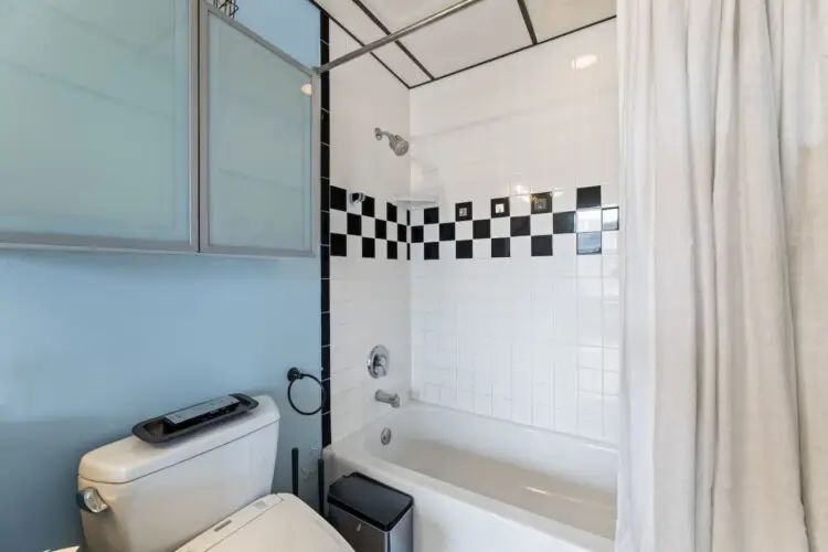 Bathroom with shower and toilet at Skyline View Loft with Chef's Kitchen: DTLA - by Open Air Homes.