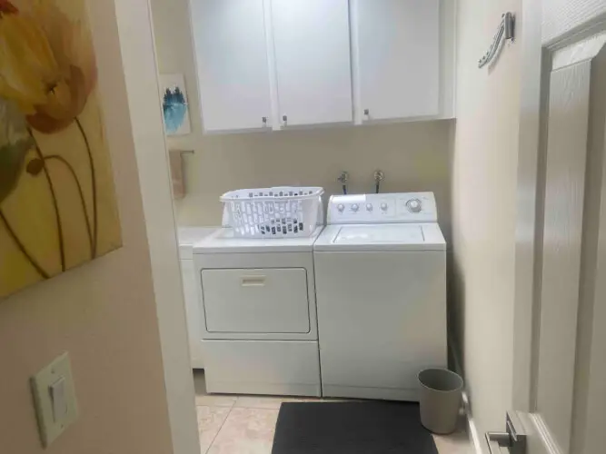 Laundry room with washer and dryer at Sunrise Serenity: Panoramic Views & Resort Living - by Open Air Homes